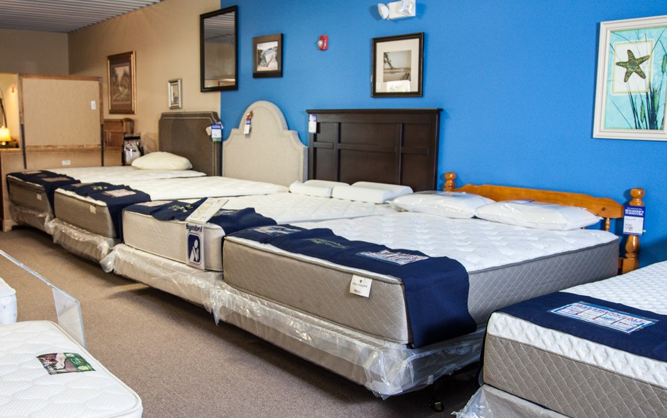 Mattress and beds in our showroom against blue wall
