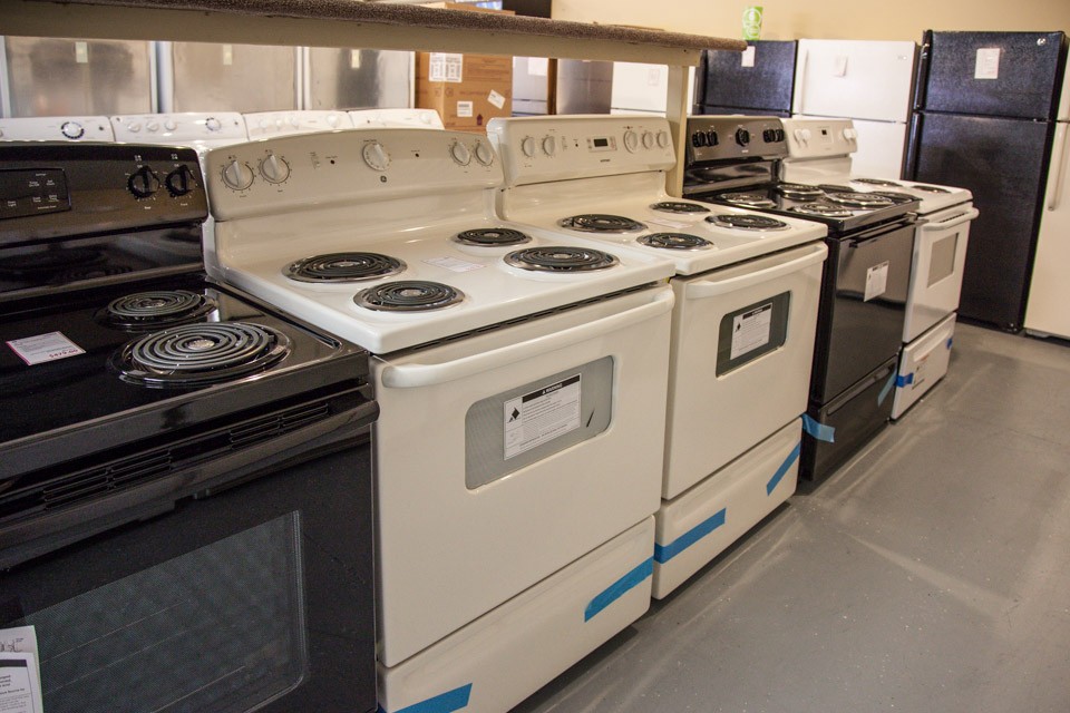 Kitchen stoves with refrigerators in background
